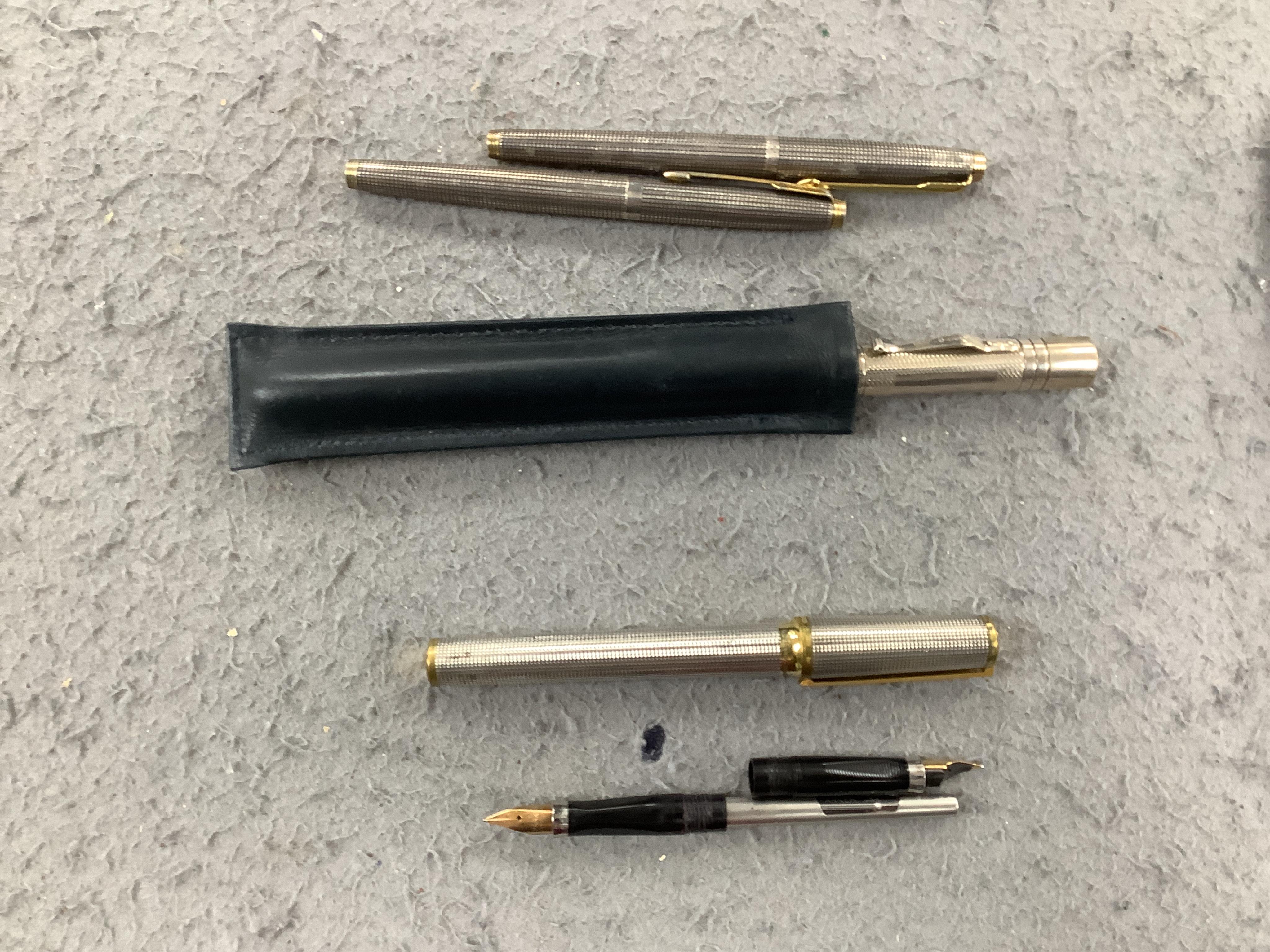 A collection of pens comprising two Sterling Parker fountain pens, one with 14k gold nib, a silver Yard-O-Lead pen, a lizard skin wallet and a Dupont fountain pen. Condition - wallet worn, pens not tested with ink for wo